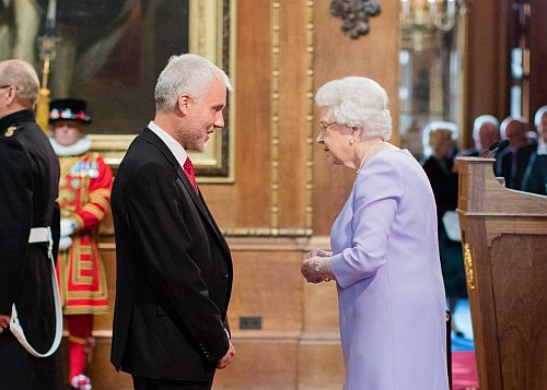 The Queen presenting the MBE to Richard